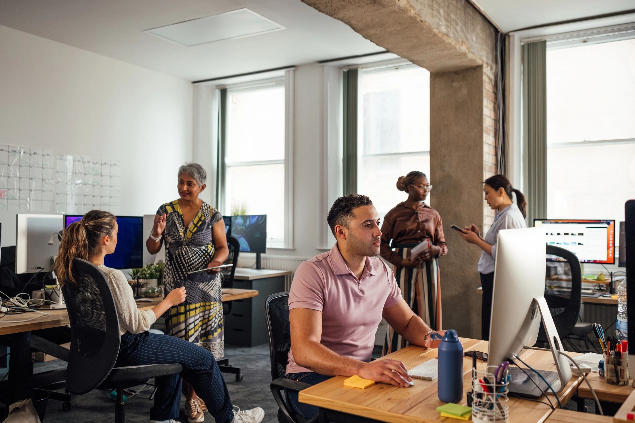 PROJEXEL DIGITAL software development team collaborating in a modern office